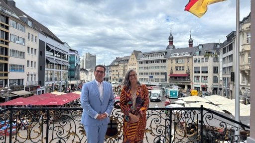 UN-Habitat Executive Director Anacláudia Rossbach and the Lord Mayor of Bonn, Guido Déus, posing together on the steps of the historic Old Town Hall in Bonn, Germany.