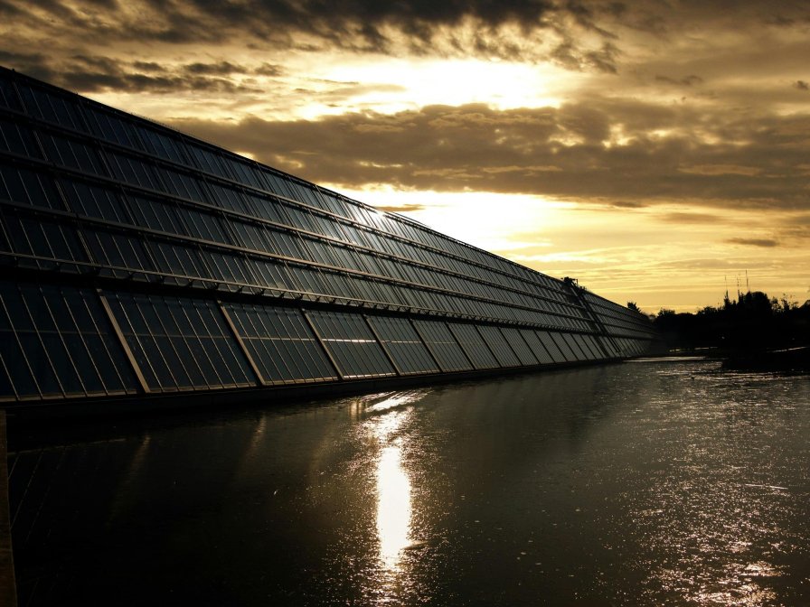 Solar panels next to a canal