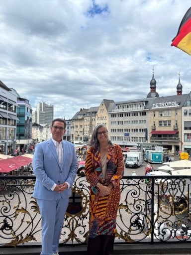 UN-Habitat Executive Director Anacláudia Rossbach and the Lord Mayor of Bonn, Guido Déus, posing together on the steps of the historic Old Town Hall in Bonn, Germany.