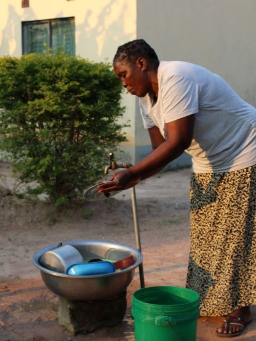 Loveness Kabasa washing dishes