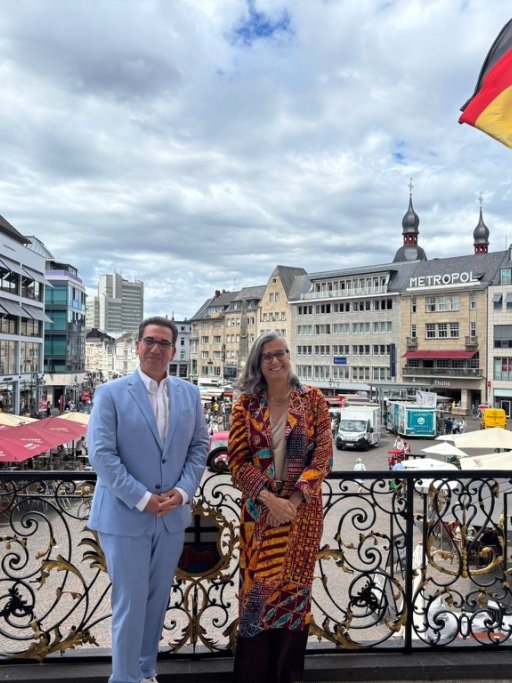 UN-Habitat Executive Director Anacláudia Rossbach and the Lord Mayor of Bonn, Guido Déus, posing together on the steps of the historic Old Town Hall in Bonn, Germany.